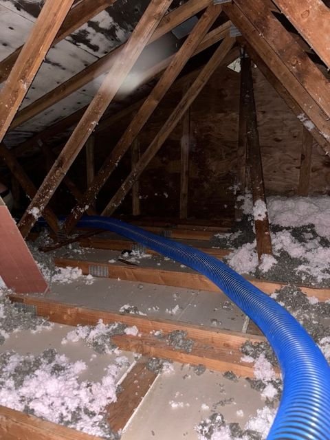 Before: bare joists, scraps of old fiberglass, hose staged