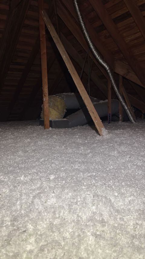 Fresh blown in cellulose around HVAC ducts on an Apex attic job