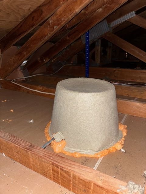 Recessed light cover sealed with foam before insulation goes in